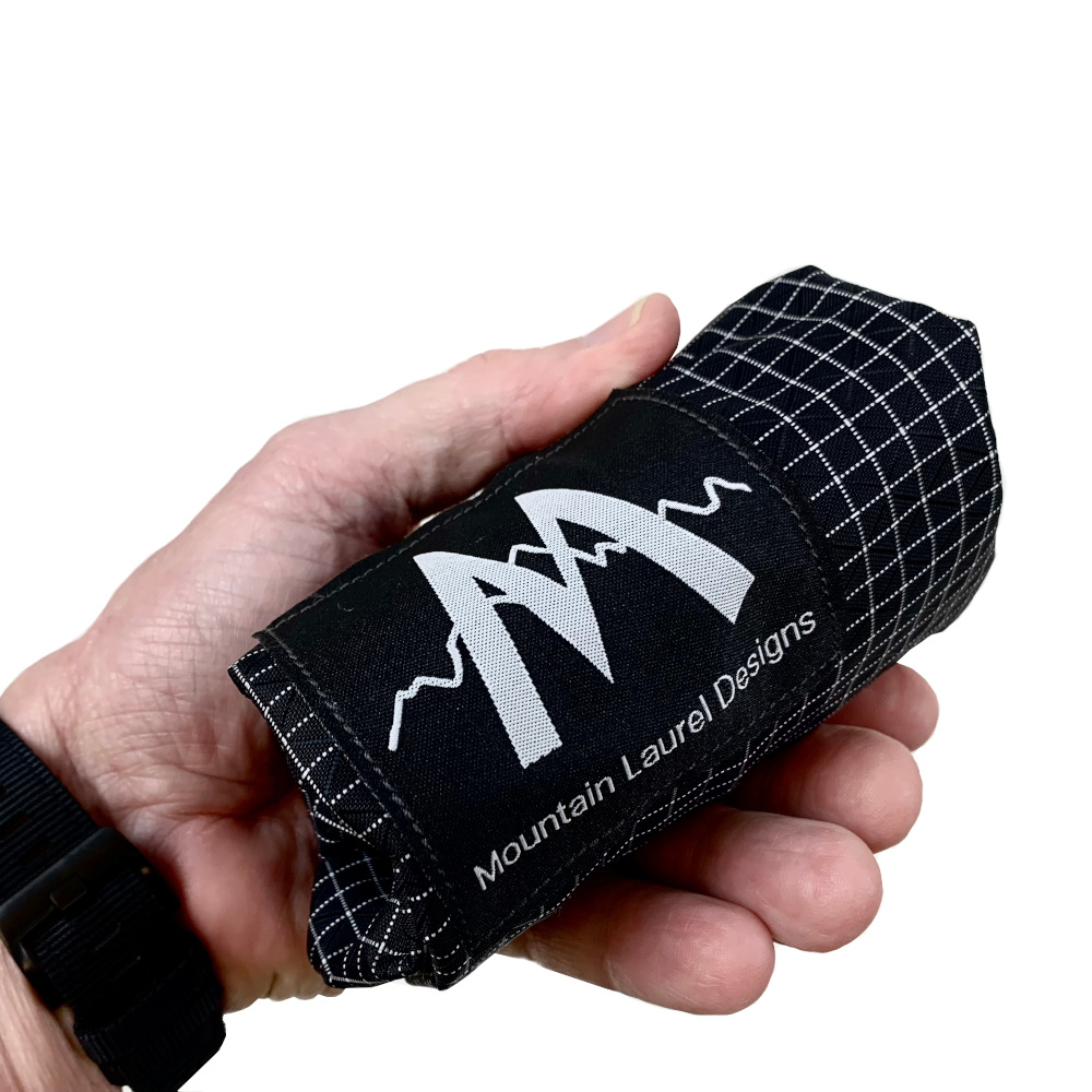 GoGetItBag Rolled Up In Hand with the MLD logo visible.